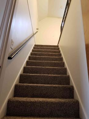 Warren house for rent - a flight of stairs with carpeted stairs leading up to a white wall and stairs
