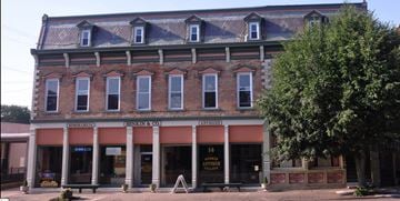 Tipp City apartment for rent - A building with a red awning and a sign that says "14 Antique Store".