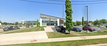 Dayton apartment for rent - A parking lot with cars and a building with the sign "Clayton Center" in front.