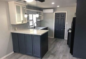 Brownsville apartment for rent - a kitchen with blue cabinets and a white counter top
