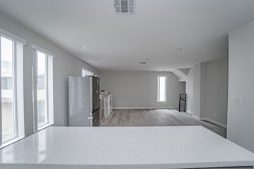 North Hollywood apartment for rent - an empty kitchen with a white counter top and a refrigerator