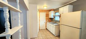 Hammond apartment for rent - A kitchen with a refrigerator, sink, and cabinets.