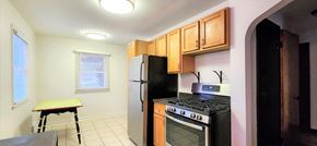 Hammond apartment for rent - A kitchen with black appliances and wooden cabinets.