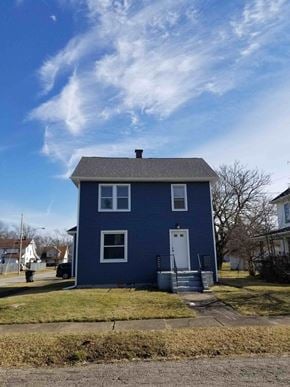 Warren house for rent - A blue house with a white door and windows.