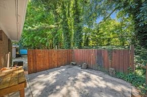 Roswell apartment for rent - A backyard with a wooden fence and a dirt path.