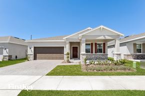 Kissimmee house for rent - a white house with a driveway and a garage door
