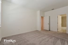 Kissimmee house for rent - a bedroom with white walls and carpet and a door to a closet
