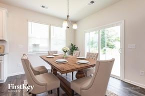 Greenville house for rent - A dining room with a wooden table and chairs.