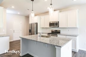 Greenville house for rent - A kitchen with granite countertops and white cabinets.