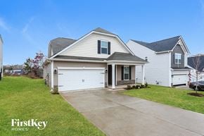 Greenville house for rent - the front of a white house with a driveway in front of it