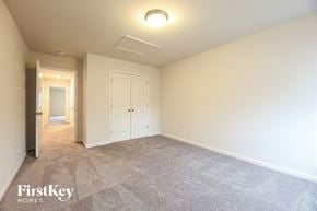 Greenville house for rent - a master bedroom with carpeted flooring and a door to a closet