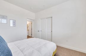 Phoenix apartment for rent - a bedroom with a white bed and a door to a bathroom