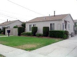 Gardena apartment for rent - A house with a grey roof and a white fence.