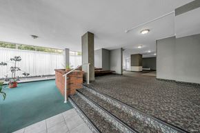 New Westminster apartment for rent - A room with a brick pillar and a green carpet.