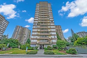 New Westminster apartment for rent - A tall residential building with a green lawn in front.
