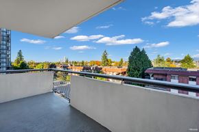 New Westminster apartment for rent - A balcony with a metal railing overlooks a cityscape.