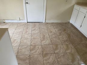 El Campo house for rent - a kitchen with a tiled floor and white cabinets