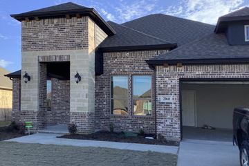 Waxahachie house for rent - A house with a garage and a driveway in front.