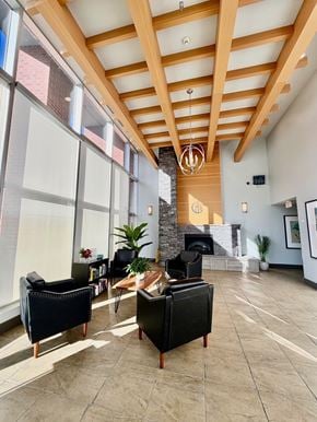 Port Moody apartment for rent - A living room with a fireplace and a large window.