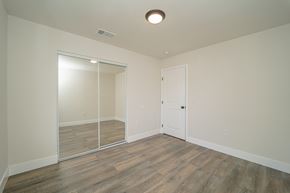 Los Angeles apartment for rent - a bedroom with a mirrored closet and hardwood flooring