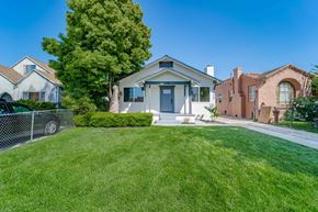 Los Angeles apartment for rent - a white house with a yard and a blue door