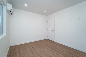 Los Angeles apartment for rent - a bedroom with white walls and wood flooring and a door