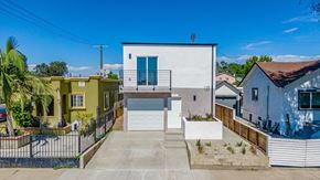 Los Angeles apartment for rent - a white house with a garage next to some buildings