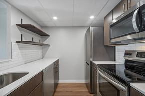 Washington apartment for rent - a renovated kitchen with stainless steel appliances and white counter tops