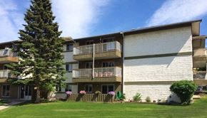 Hinton apartment for rent - A large apartment complex with a green lawn in front.
