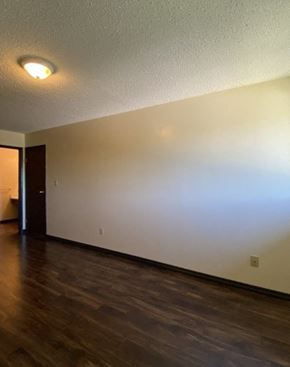 Hinton apartment for rent - A room with a wooden floor and a light on the ceiling.