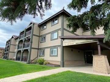 Cold Lake apartment for rent - the exterior of a apartment building with a sidewalk and grass