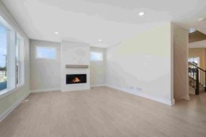 Woodbury house for rent - A modern living room with a fireplace and a staircase.