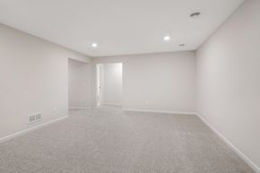 Woodbury house for rent - A spacious room with carpeted floor and white walls.