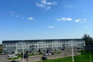 Aberdeen apartment for rent - A large white building with a parking lot in front.