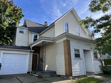 Syracuse apartment for rent - a white house with a white garage door