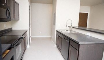 Fargo apartment for rent - a kitchen with stainless steel counter tops and a sink