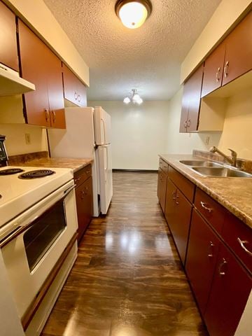 Hinton apartment for rent - A kitchen with brown cabinets and a white refrigerator.