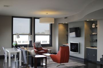 Grand Rapids apartment for rent - a living room with chairs and a table and a fireplace