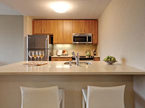 Mount Vernon apartment for rent - a kitchen with a counter and chairs and a sink with wine glasses