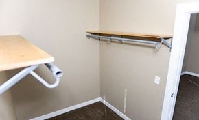 Fargo apartment for rent - a walk in closet with a bar and a desk