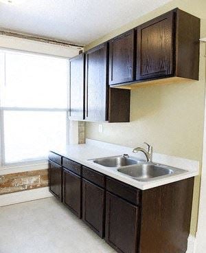 Fargo apartment for rent - a kitchen with a sink and cabinets and a window