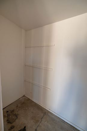 Palm Desert apartment for rent - a room with white walls and shelves on the wall