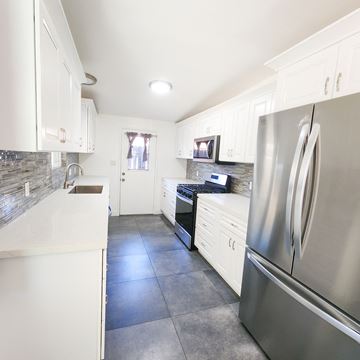 Palm Desert apartment for rent - a kitchen with stainless steel appliances and white cabinets