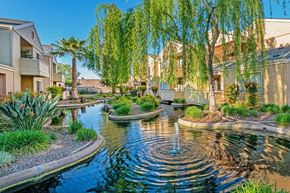 Fresno apartment for rent - A pond with a fountain in the middle of a residential area.