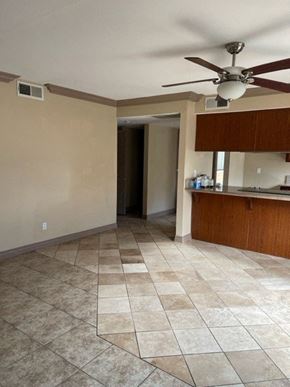 Fresno apartment for rent - A room with a ceiling fan and tile flooring.