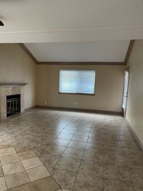 Fresno apartment for rent - A room with a fireplace and tiled flooring.