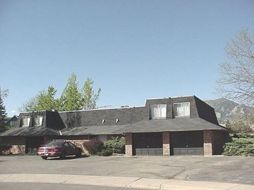 Boulder apartment for rent - A house with a red car parked in front.