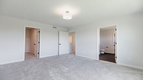Hugo house for rent - A large empty room with a carpeted floor and white walls.