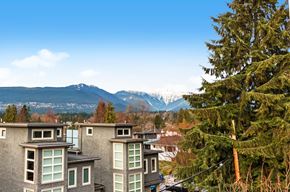 North Vancouver apartment for rent - A mountain range is in the background of a residential area.