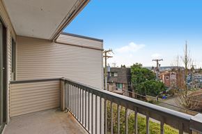 North Vancouver apartment for rent - A balcony with a metal railing and a view of a residential area.